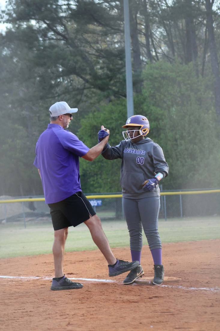 Coach and player celebrating on base