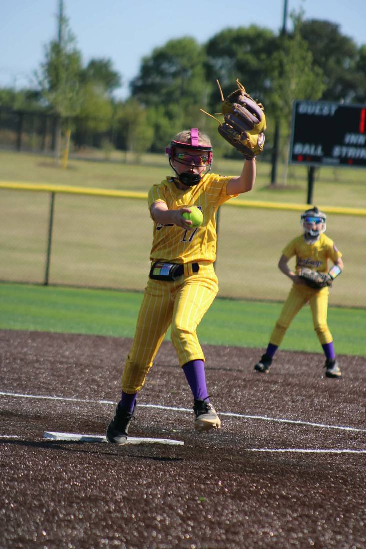 Mustangs pitcher delivering a pitch in yellow uniform